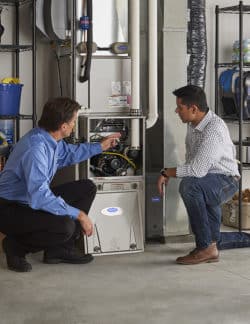 Carrier dealer with home owner showing him the new furnace